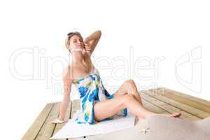 Beach - woman sunbathing with pareo and sunglasses