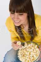 Smiling female teenager with popcorn