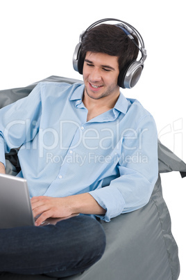 Young businessman relax with music and laptop