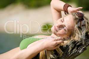 Blond woman relax in bikini at lake