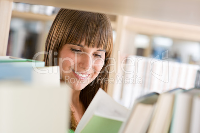 Student in library - cheerful woman read book