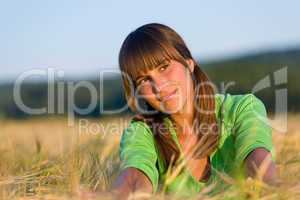 Portrait of happy woman in sunset corn field