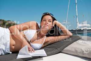 Attractive woman sunbathing on luxury boat