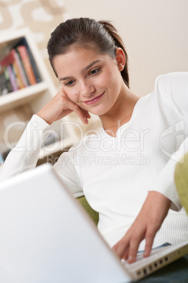 Students - Happy teenager with laptop in modern lounge
