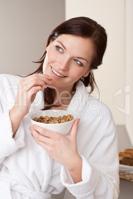 Happy woman in bathrobe holding  cereals for breakfast