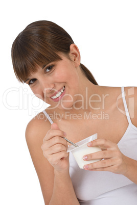 Female teenager eat healthy yogurt for breakfast