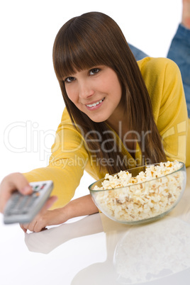 Happy female teenager watching television