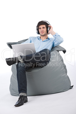 Young businessman relax with music and laptop