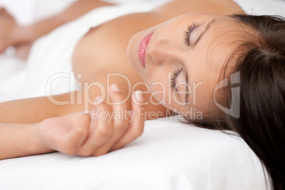 Beautiful naked woman sleeping in white bed