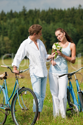 Romantic young couple walking with old bike Romantic young couple walking with old bike
