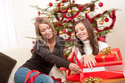 Two women packing Christmas present