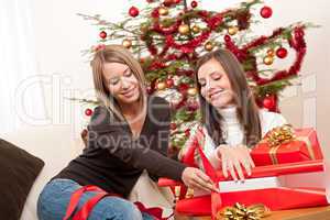 Two women packing Christmas present