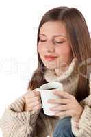 Winter portrait of happy woman holding cup of coffee