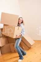 Moving house: Woman holding heavy carton box