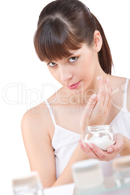 Body care: Young woman with jar of moisturizer in bathroom