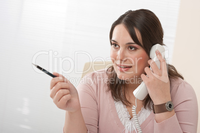 Young secretary on phone at modern office