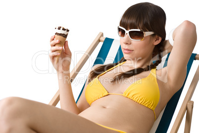 Beautiful woman in bikini with ice cream cone in summer