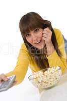 Happy female teenager watching television