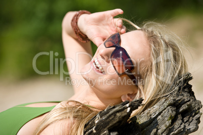 Blond woman in bikini sunbathe on beach