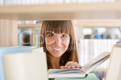 Student in library - cheerful woman hold book