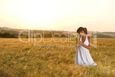 Romantic brunette woman in sunset corn field