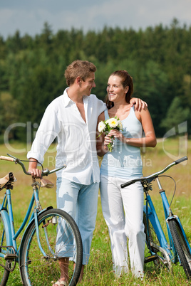 Romantic young couple walking with old bike Romantic young couple walking with old bike