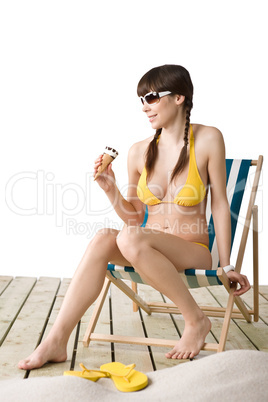 Beautiful woman in bikini with ice cream cone in summer