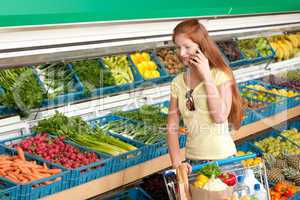 Grocery store shopping - Red hair woman in a supermarket