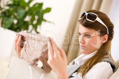 Young businesswoman unpacking shopping bag