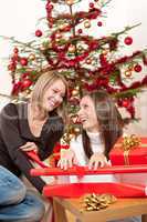 Two women packing Christmas present