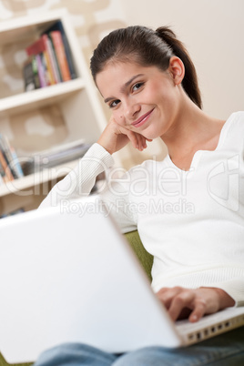 Students - Happy teenager with laptop sitting on armchair