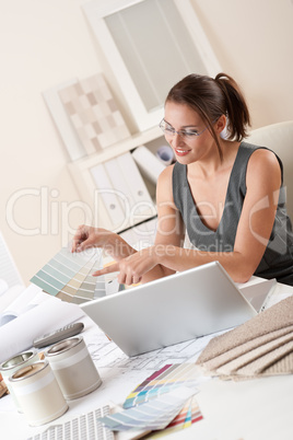 Female interior designer working at office