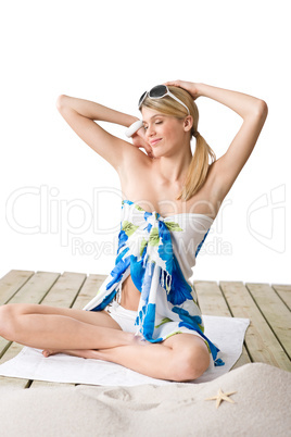 Beach - woman sunbathing with pareo and sunglasses