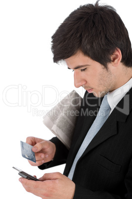 Young businessman holding mobile phone and credit card