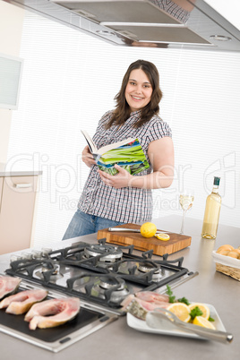 Cook - plus size woman grill fish in kitchen