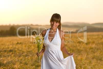 Romantic woman in sunset corn field wear dress