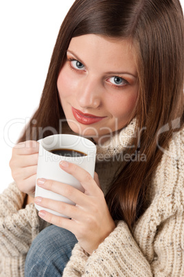 Winter portrait of happy woman holding cup of coffee