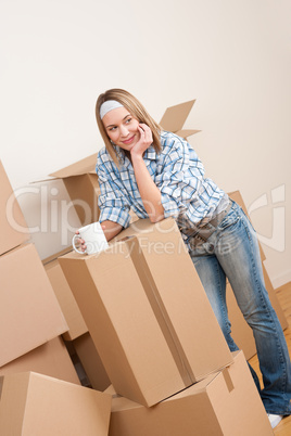 Moving house: Woman with box in new home