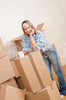 Moving house: Woman with box in new home