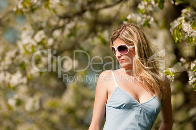 Spring - Young woman under blossom tree enjoy sun