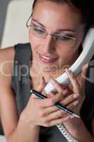 Businesswoman calling on the phone at office