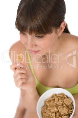 Female teenager eat healthy  cereal for breakfast