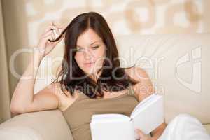 Young woman read book on sofa