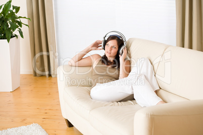 Woman with headphones listen to music  in lounge
