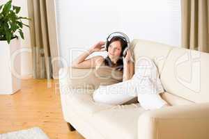 Woman with headphones listen to music  in lounge
