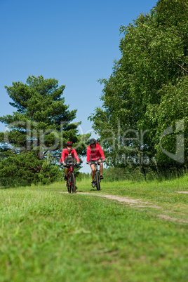 Young couple with mountine bike in spring nature