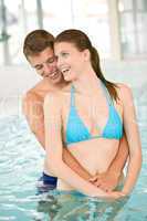 Swimming pool - young loving couple have fun