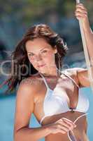 Beautiful woman on luxury yacht holding rope