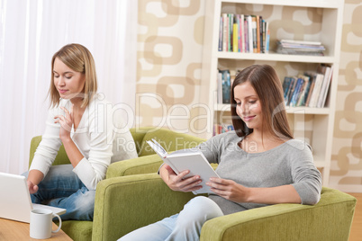 Students - Two teenage girls with laptop and book