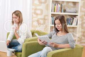 Students - Two teenage girls with laptop and book